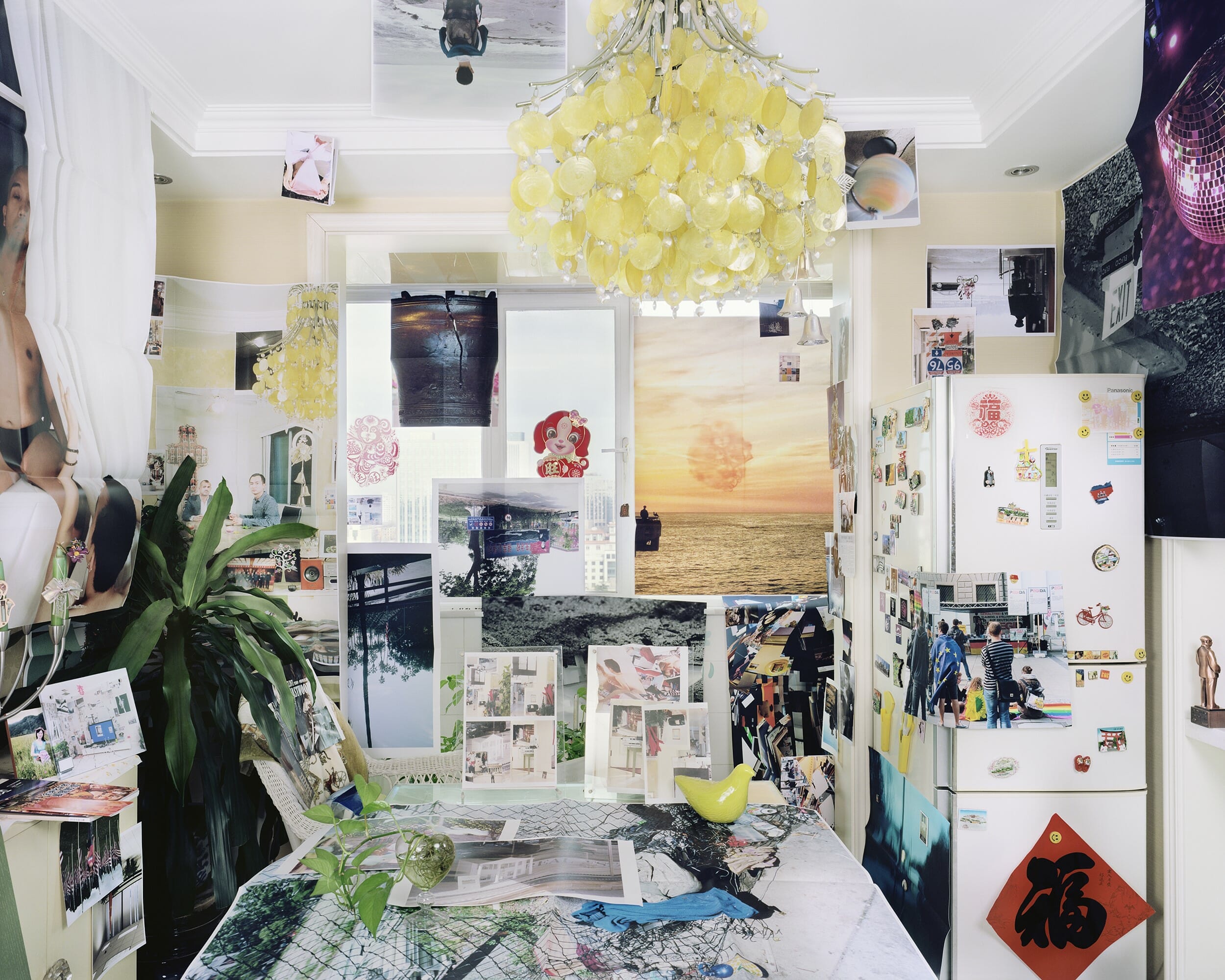 Showing a kitchen or dining area covered in images or prints with Chinese decoration