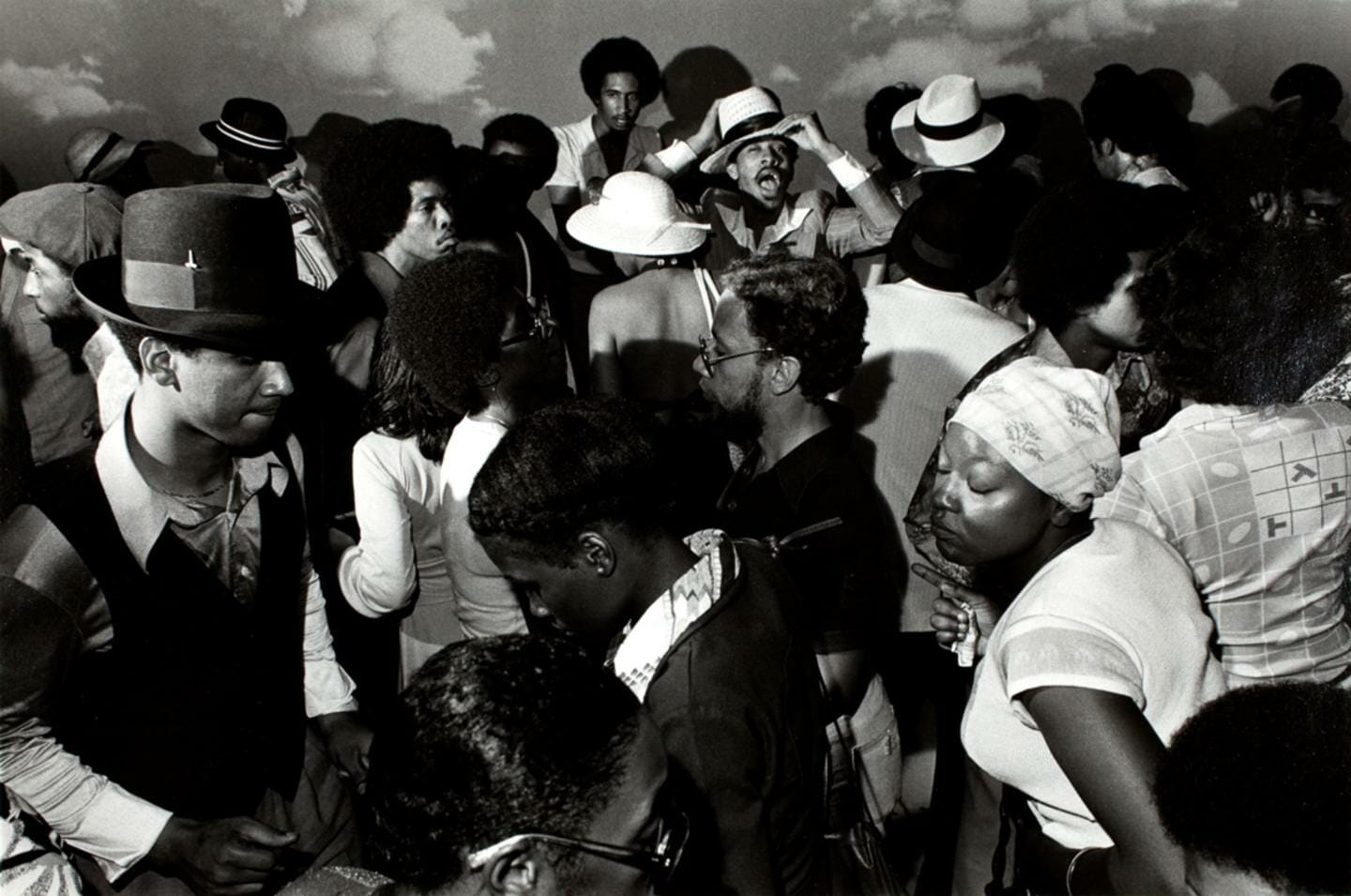 large group of people dancing indoors at a party