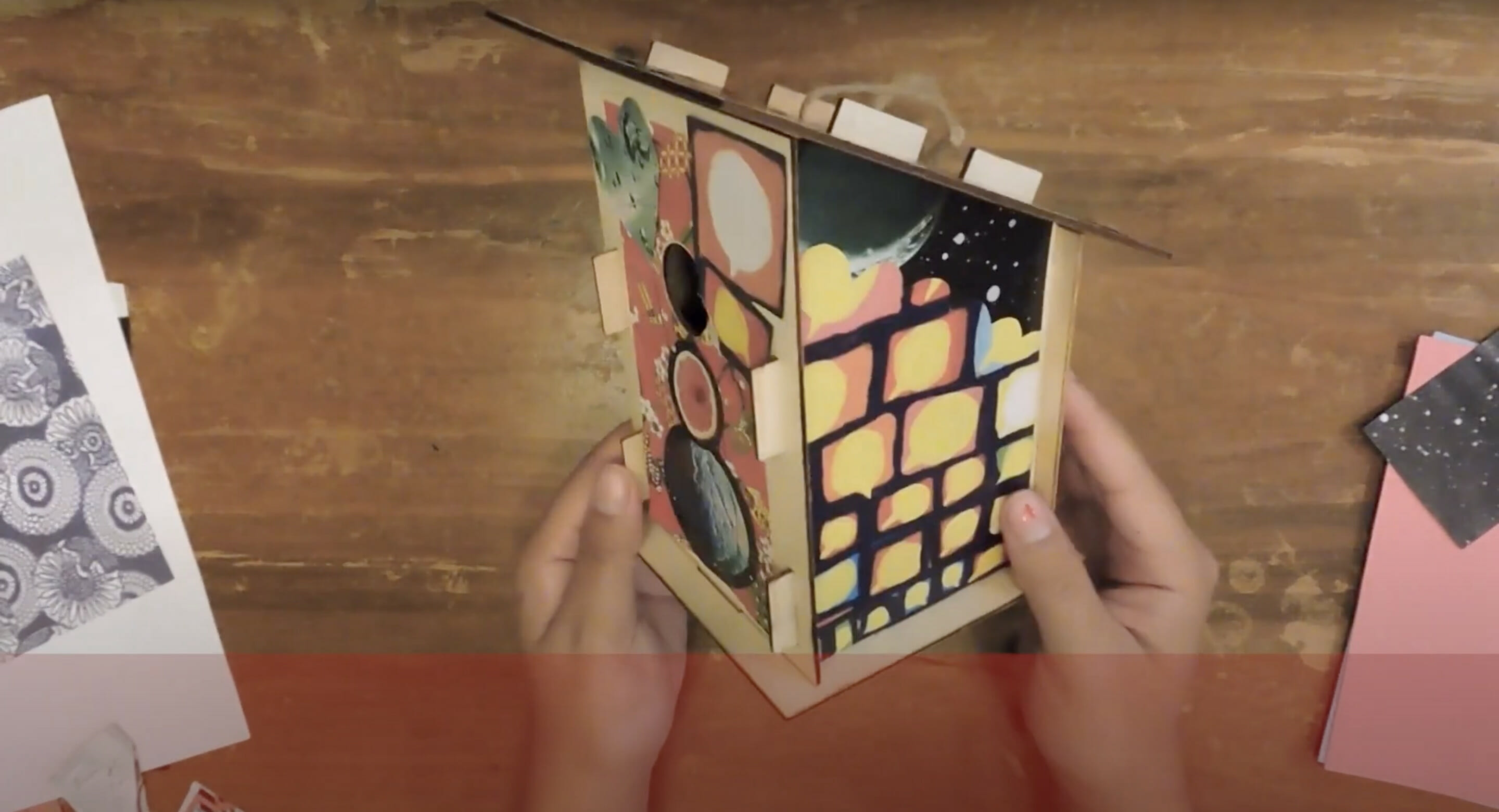 person holding a decorated bird house art project