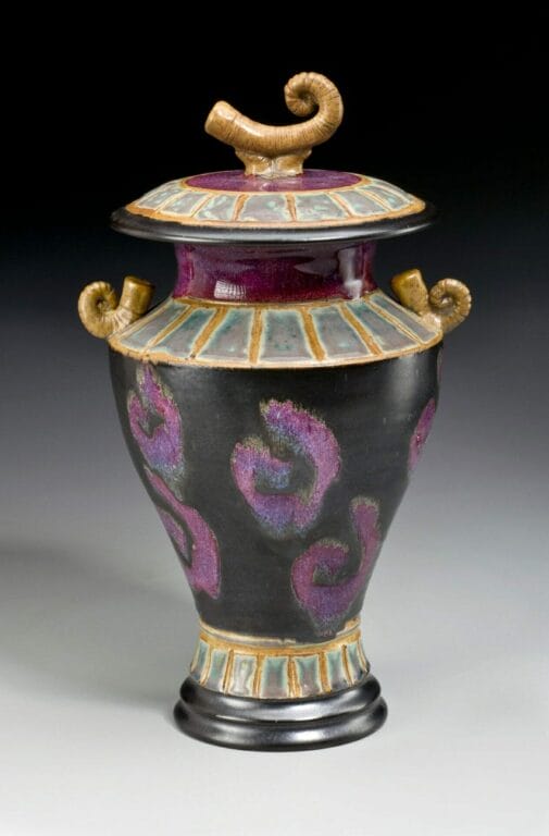 ceramic vase with abstract horn-like shapes and painted spirals