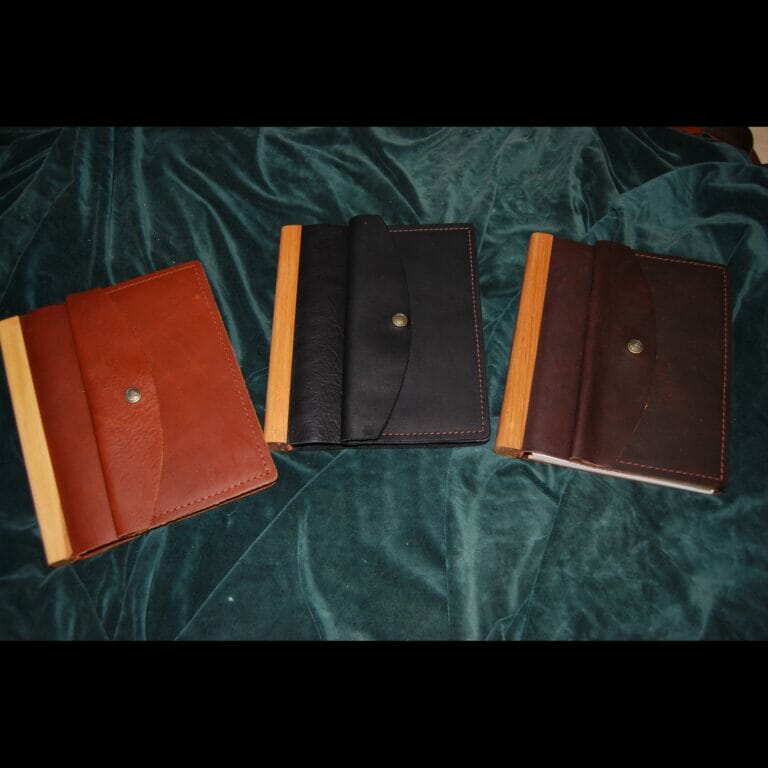 Leather bound items on a green cloth