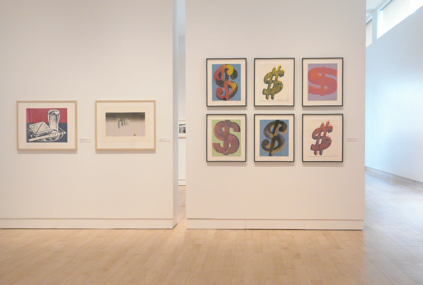 installation view of "In Depth," featuring eight framed artworks hanging on two mobile walls