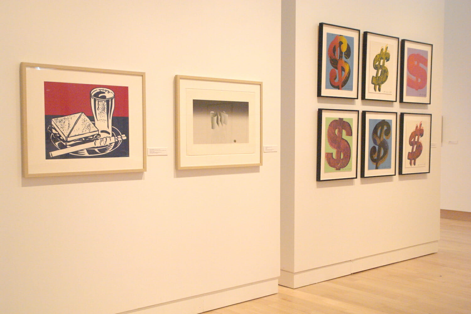 installation view of "In Depth," featuring eight framed artworks on two different walls