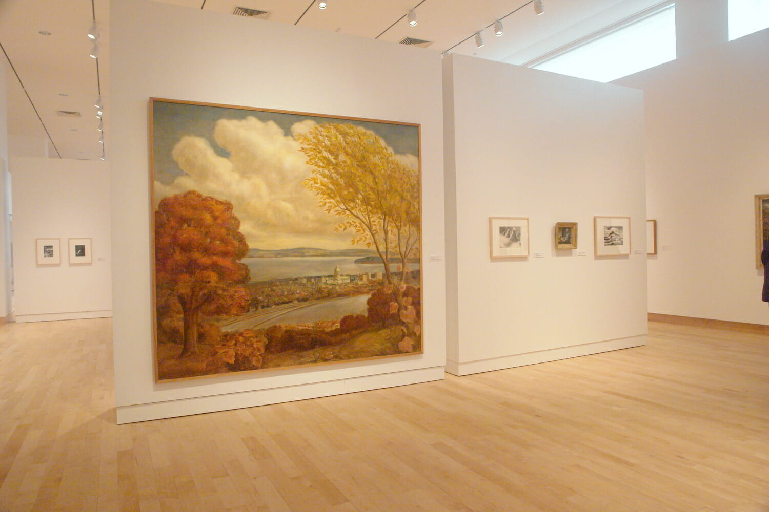 installation view of "In Depth," featuring at least seven framed artworks hanging across different walls