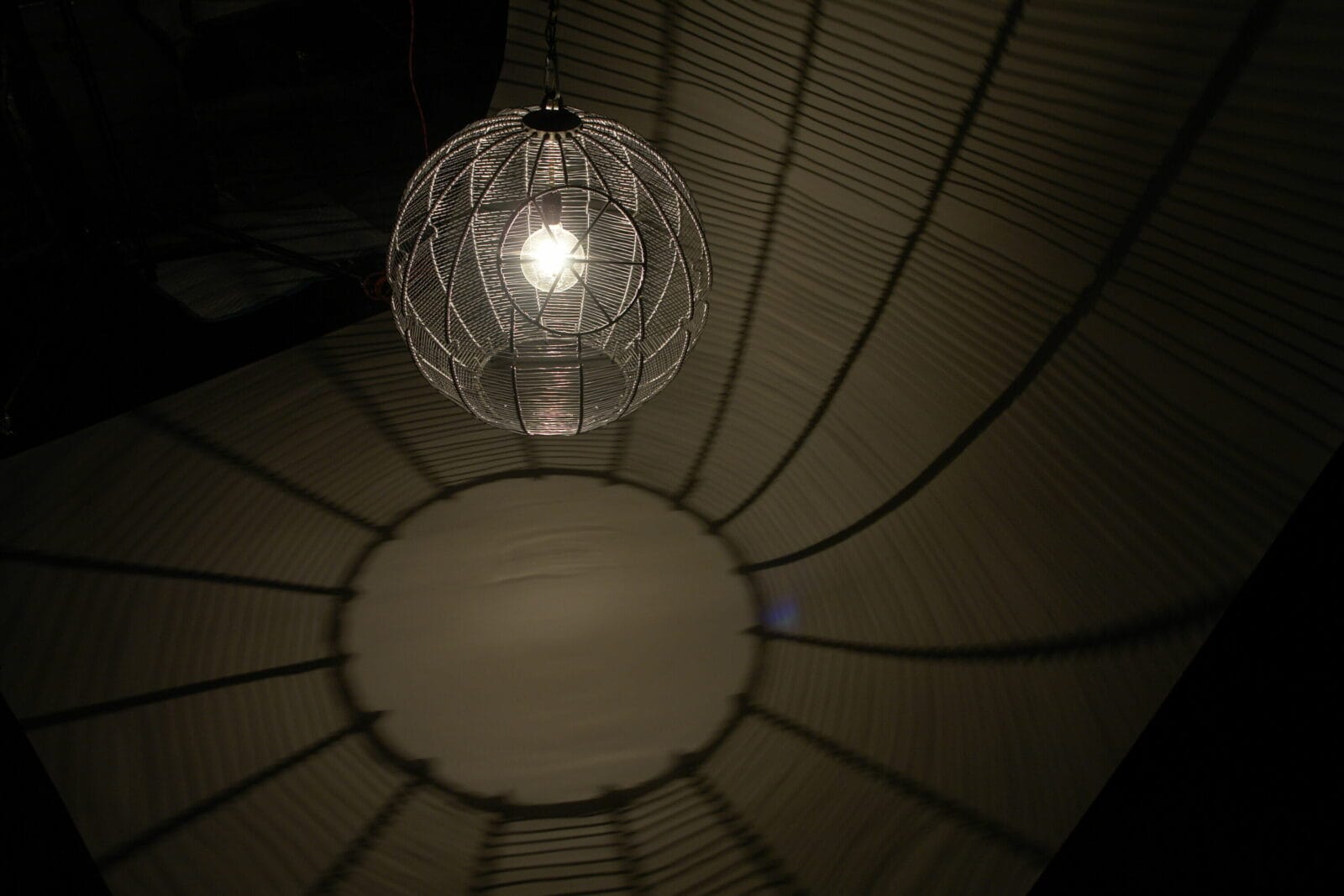 Charm (Death Star). Artist: Martin Kersels. Date: 2006. Medium: aluminum wire, metal, light bulb, and chain.
