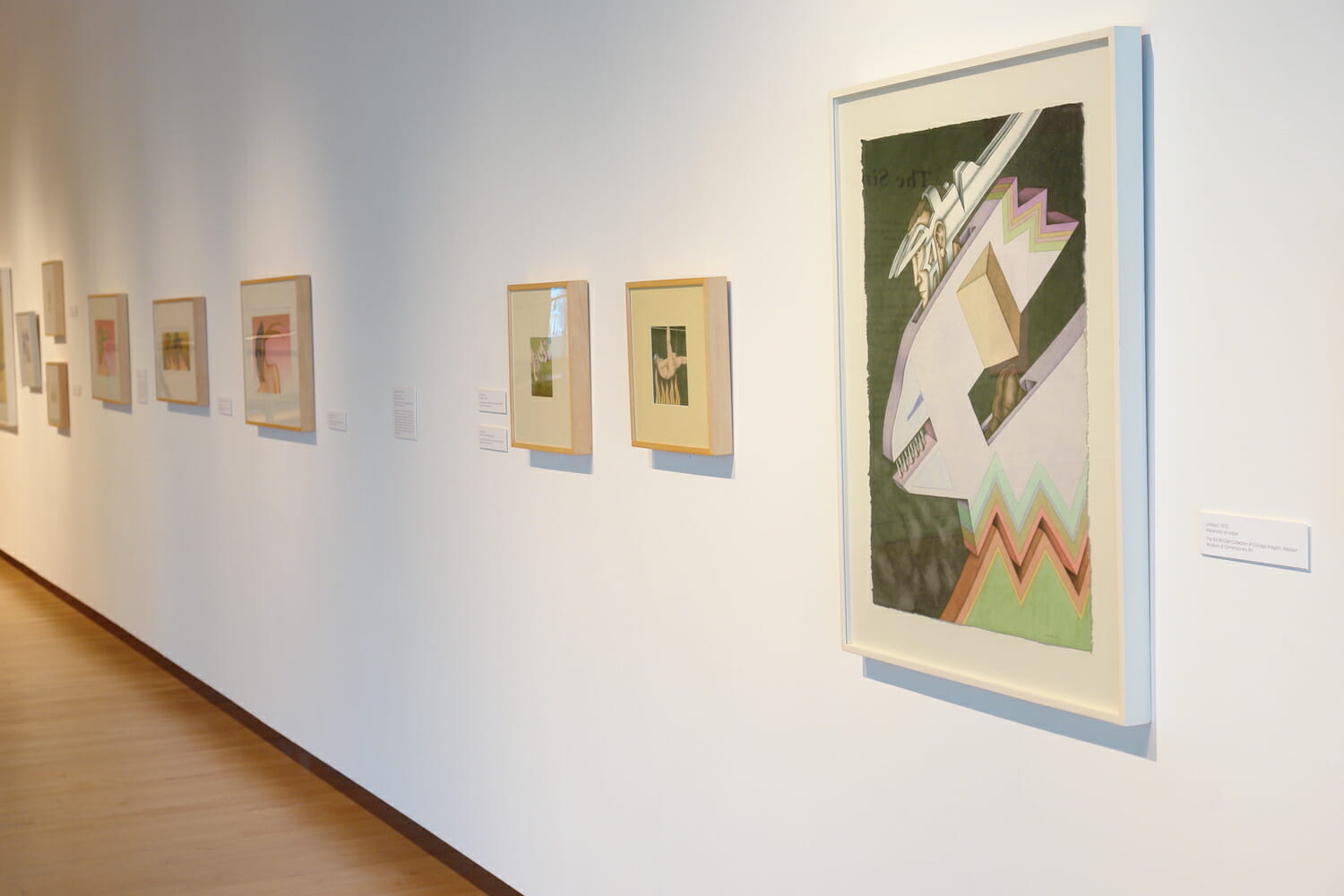 installation view of "The Singing Bird Rooms of Robert Lostutter" with framed artworks hanging across the wall