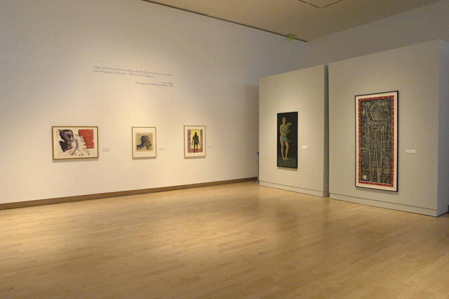 installation view of "Something Wicked This Way Comes" showing framed artworks hanging on the wall