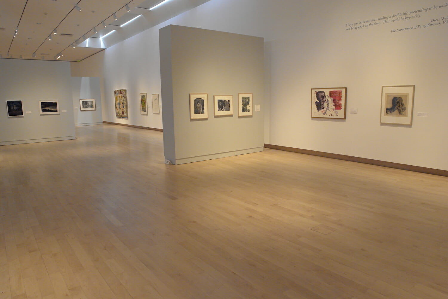 installation view of "Something Wicked This Way Comes" showing framed artworks hanging on the wall