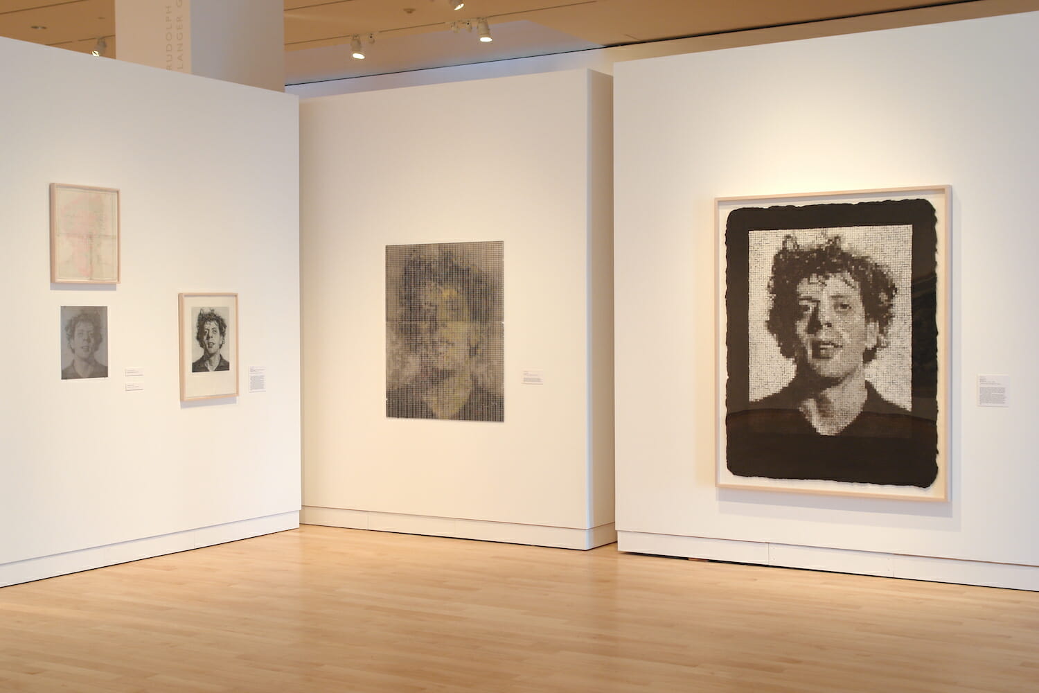installation view of the Chuck Close Prints exhibition, featuring framed artworks on several different walls in a gallery space
