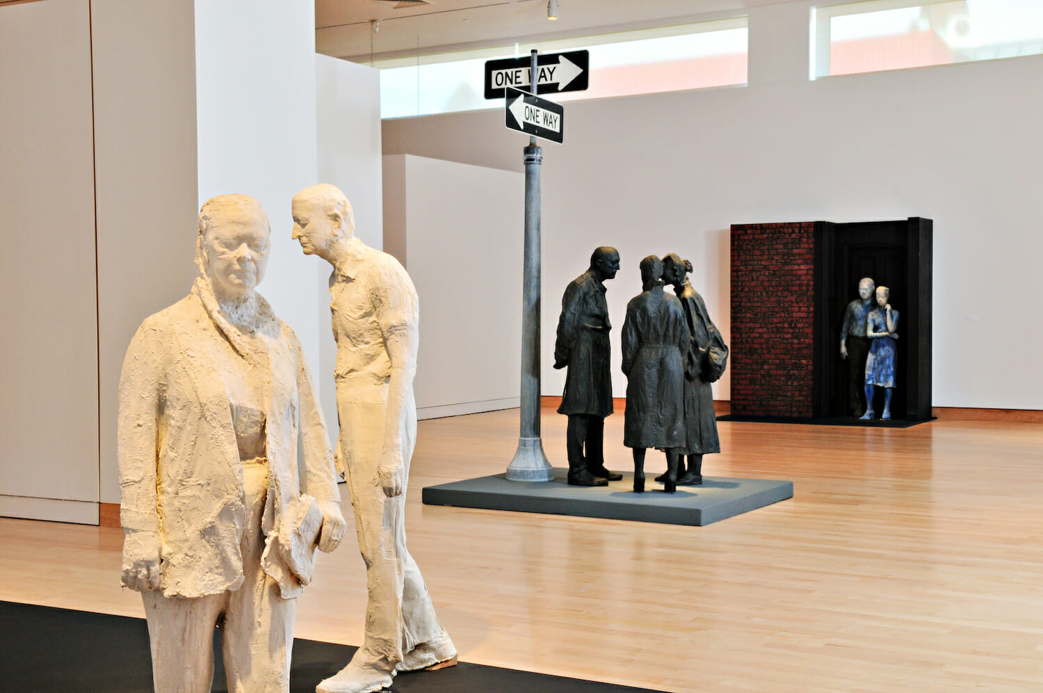 gallery installation view of George Segal: Street Scenes, featuring a variety of sculptures featuring people gathered together