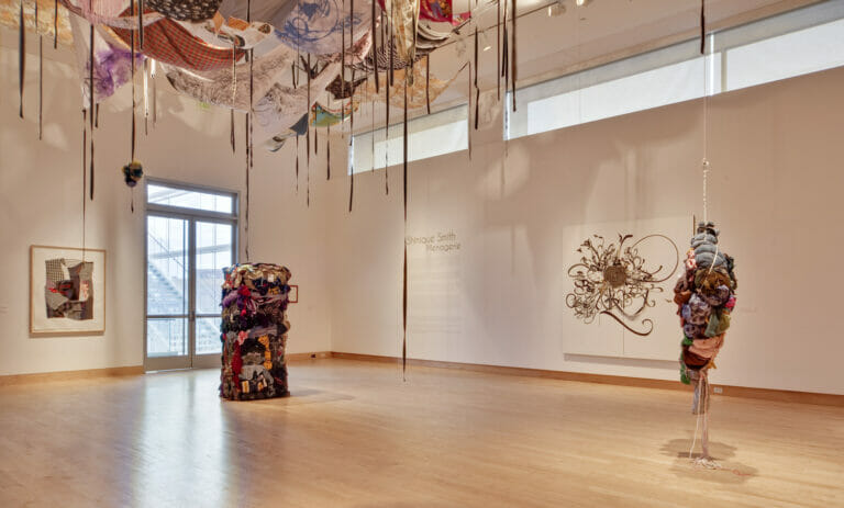 installation view of Shinique Smith: Menagerie featuring a variety of abstract sculptures and paintings