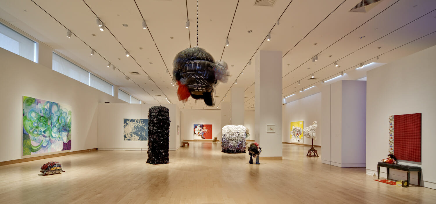 installation view of Shinique Smith: Menagerie featuring a variety of abstract sculptures and paintings