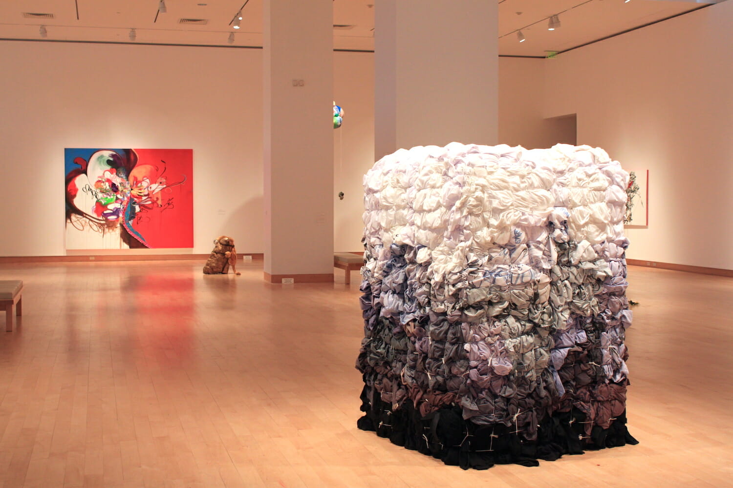 installation view of Shinique Smith: Menagerie featuring a variety of abstract sculptures and paintings