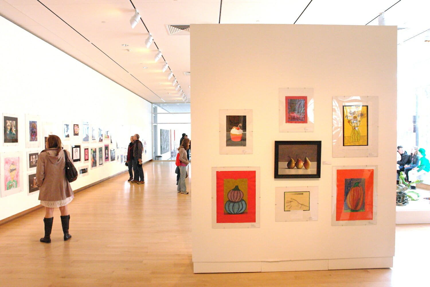 gallery installation view of the 2013 Young at Art exhibition featuring artworks by children on display on a wall