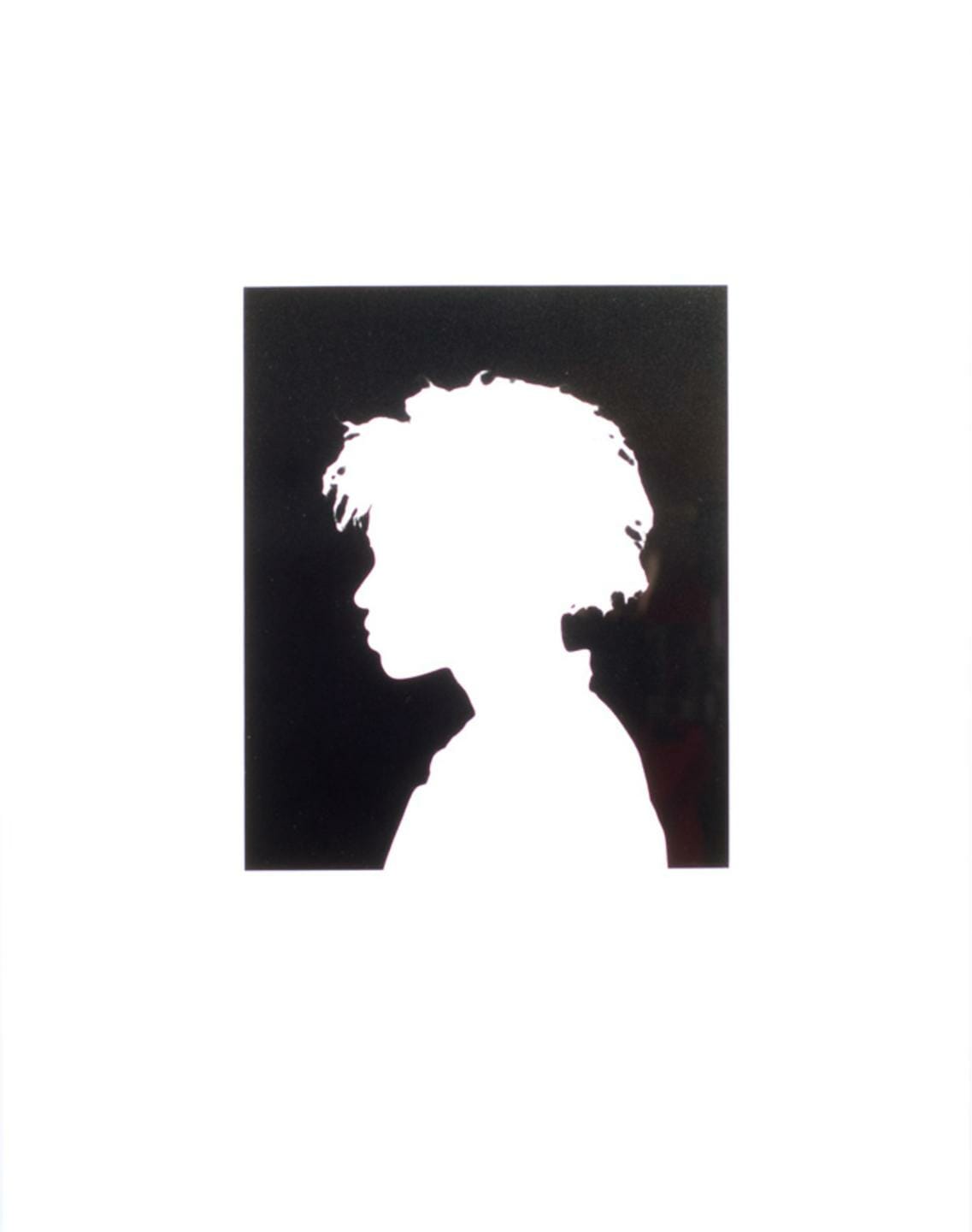 white silhouette of a person's profile on a dark surface