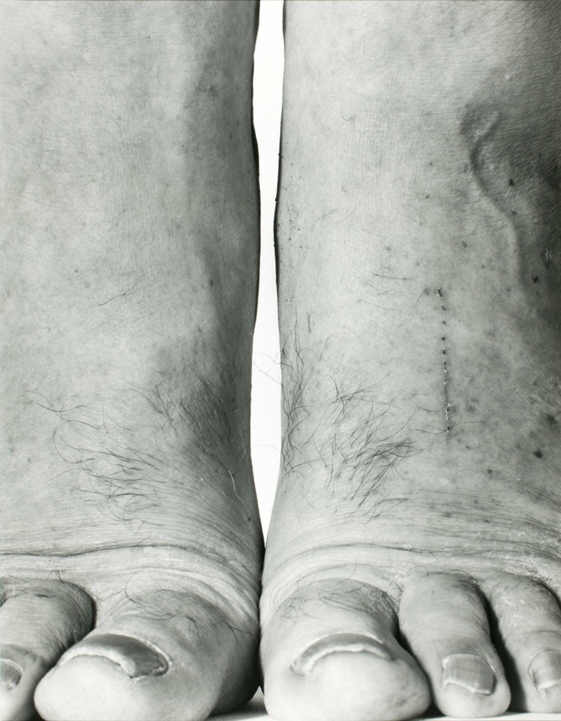 close up of two feet standing on tippy toes