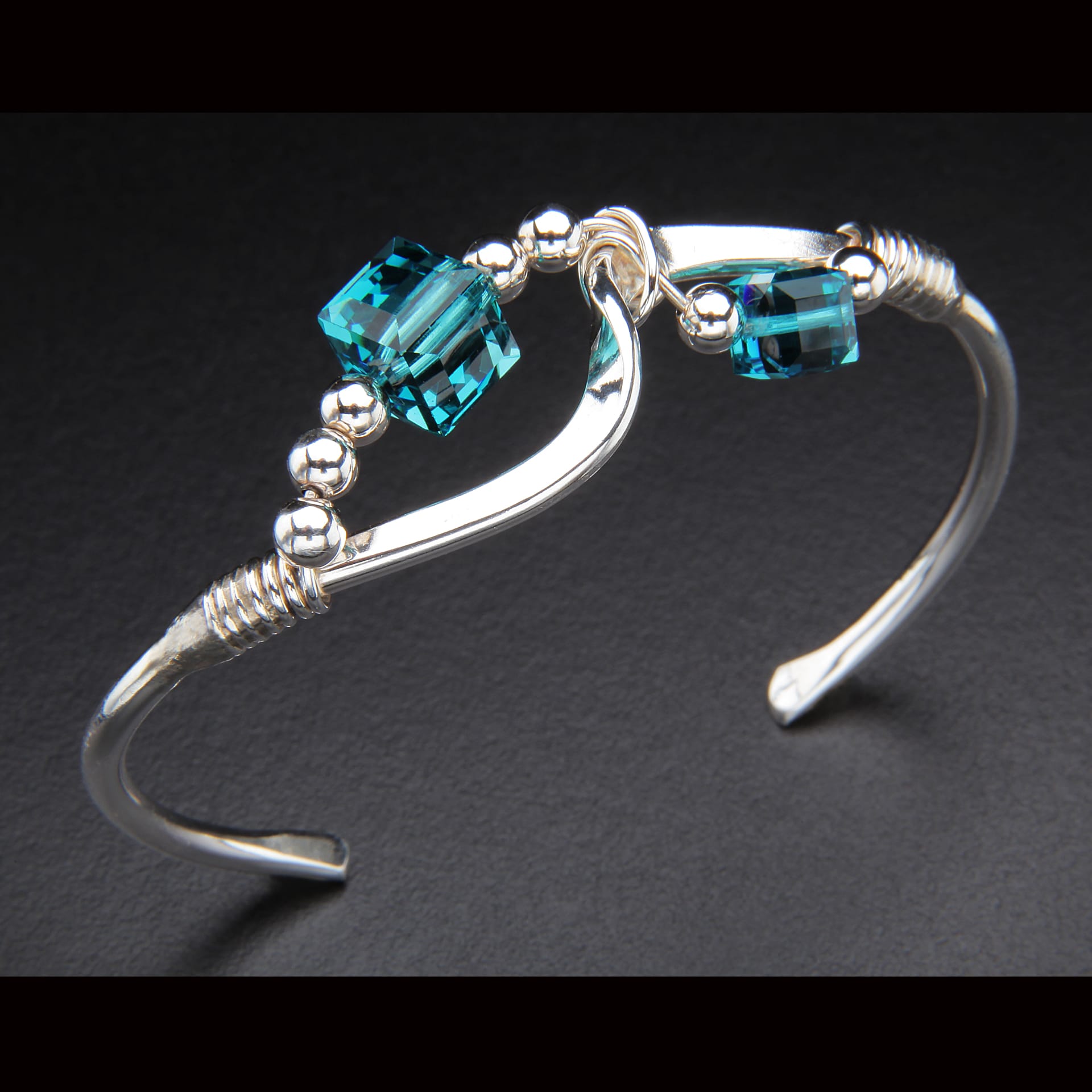 a silver bracelet with blue stones.