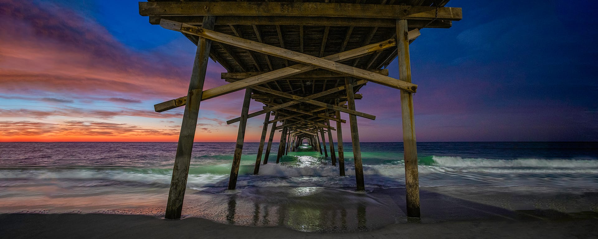 beach sunset under the pier