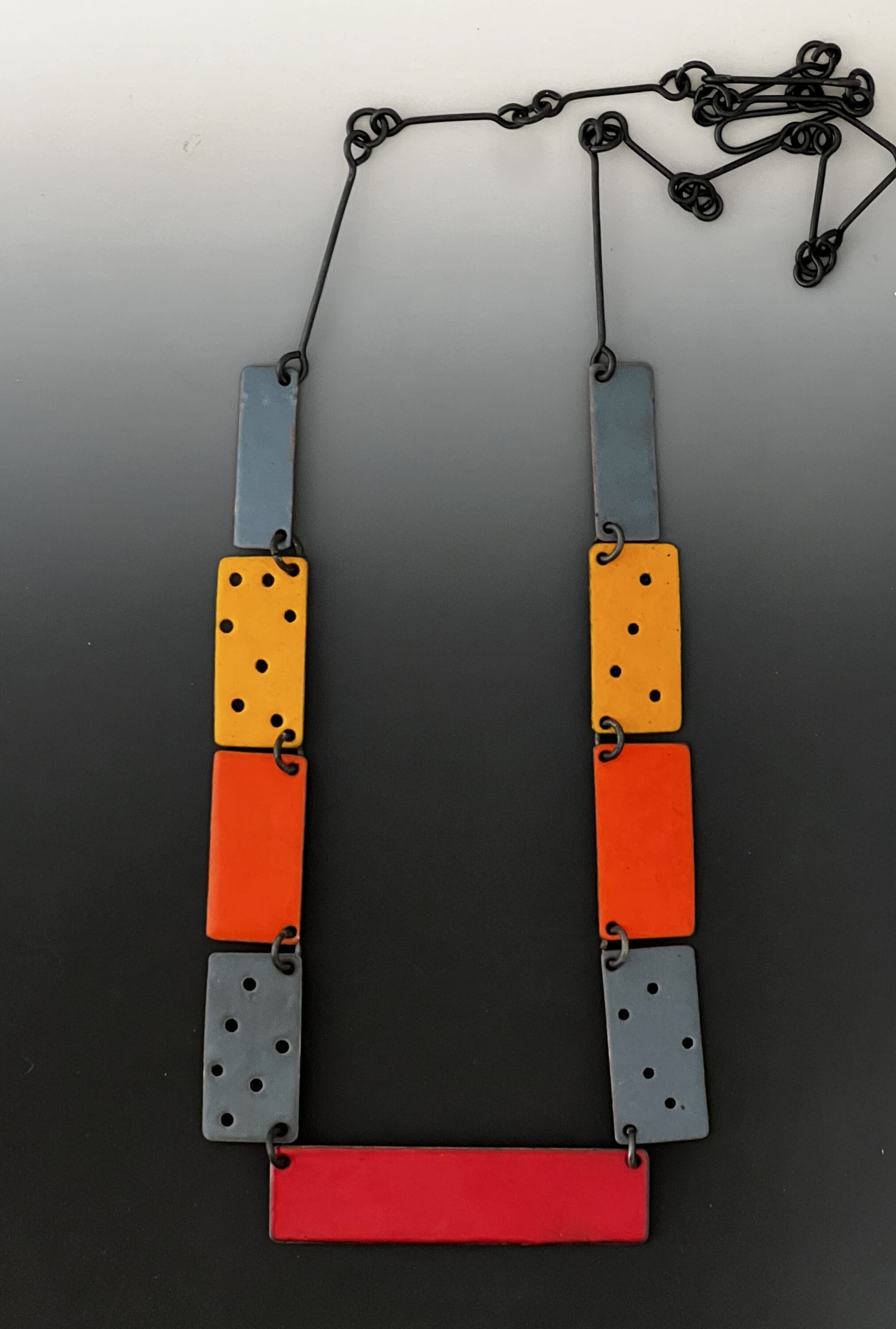 a necklace of rectangular blocks of blue, yellow, and red.