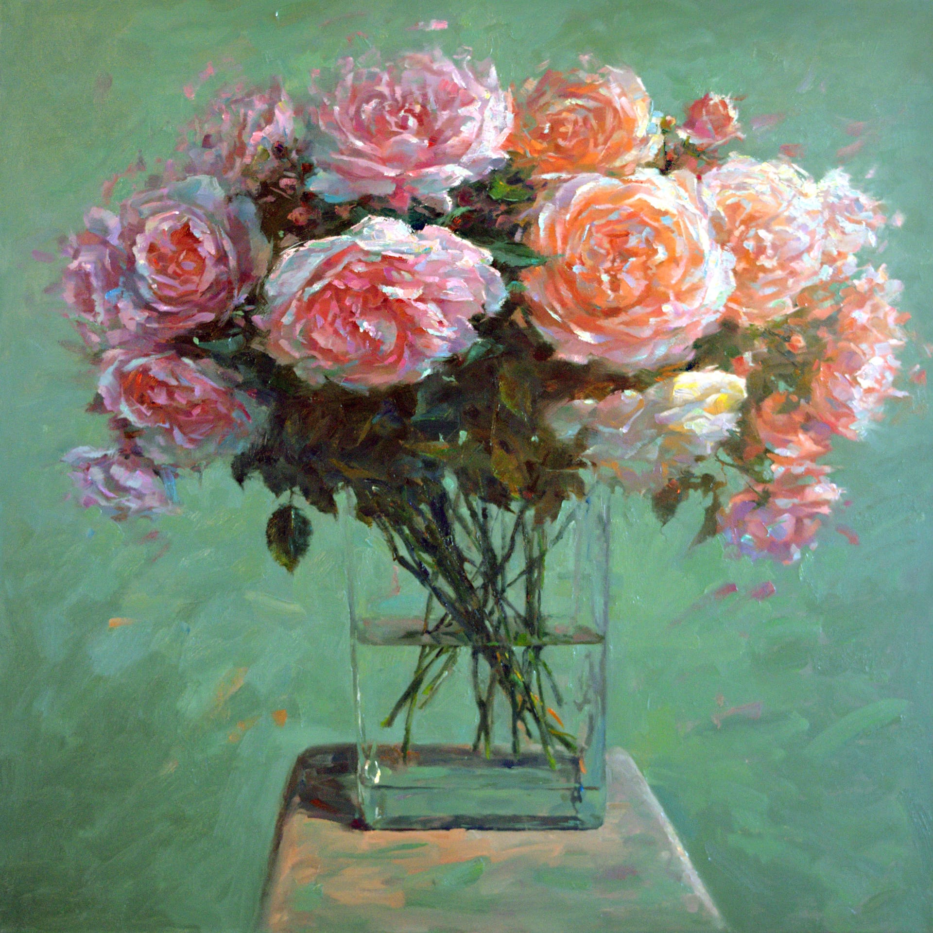 pink flowers in glass with a green backdrop.