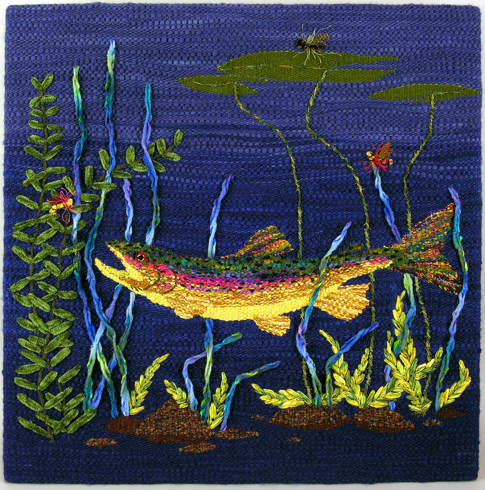 Hand-woven tapestry with hand-dyed wool depicting a fish in an underwater setting.