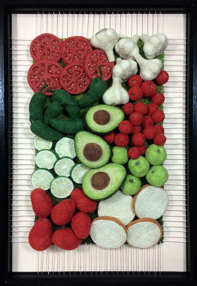 3D fiber art depicting various fruits and vegetables within a frame.