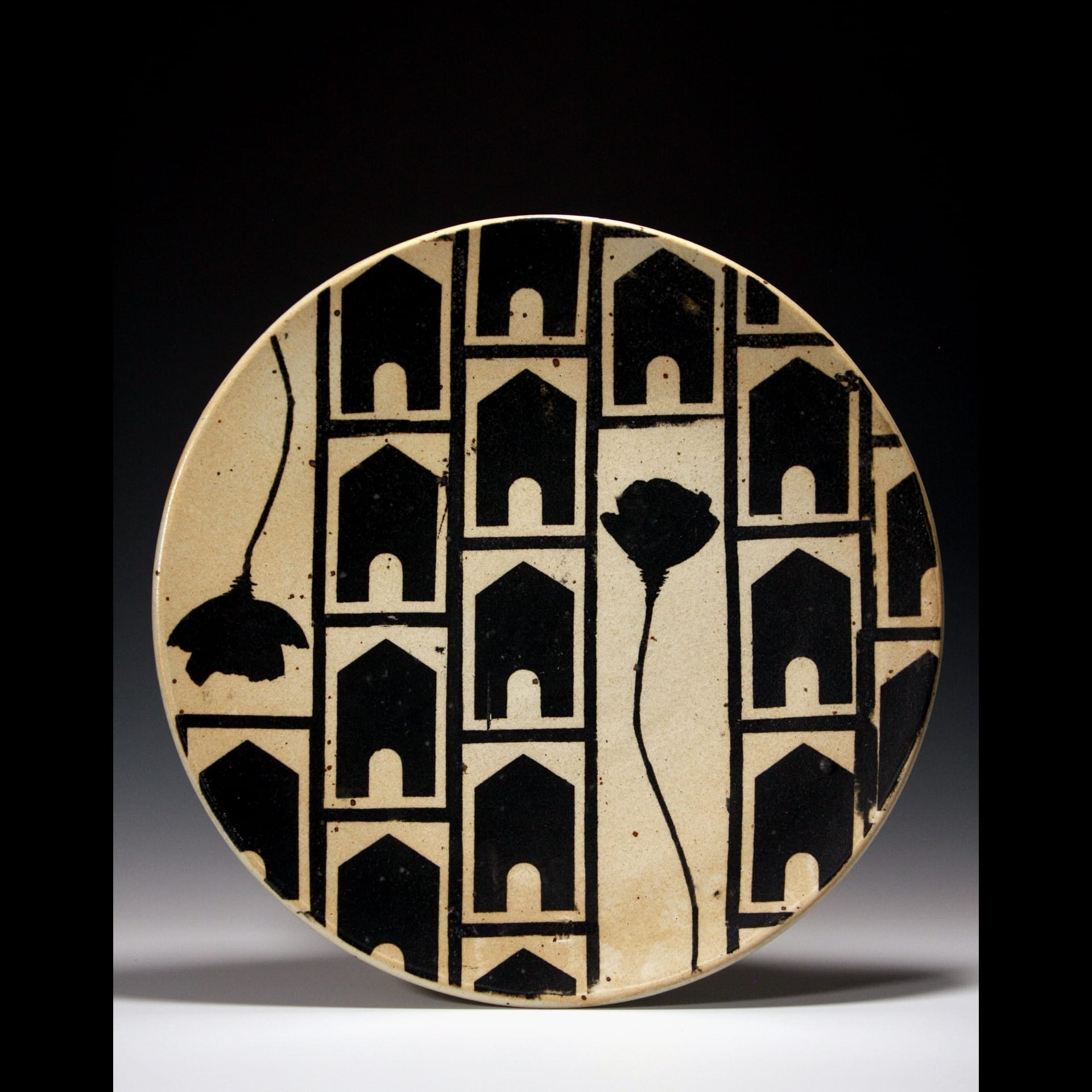 A black and white plate with a house illustration pattern.