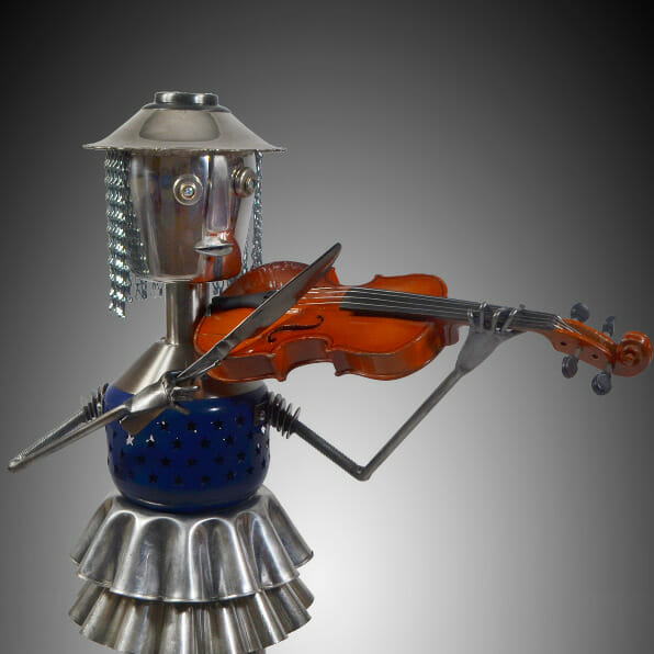 Metal sculpture of a person playing a violin.