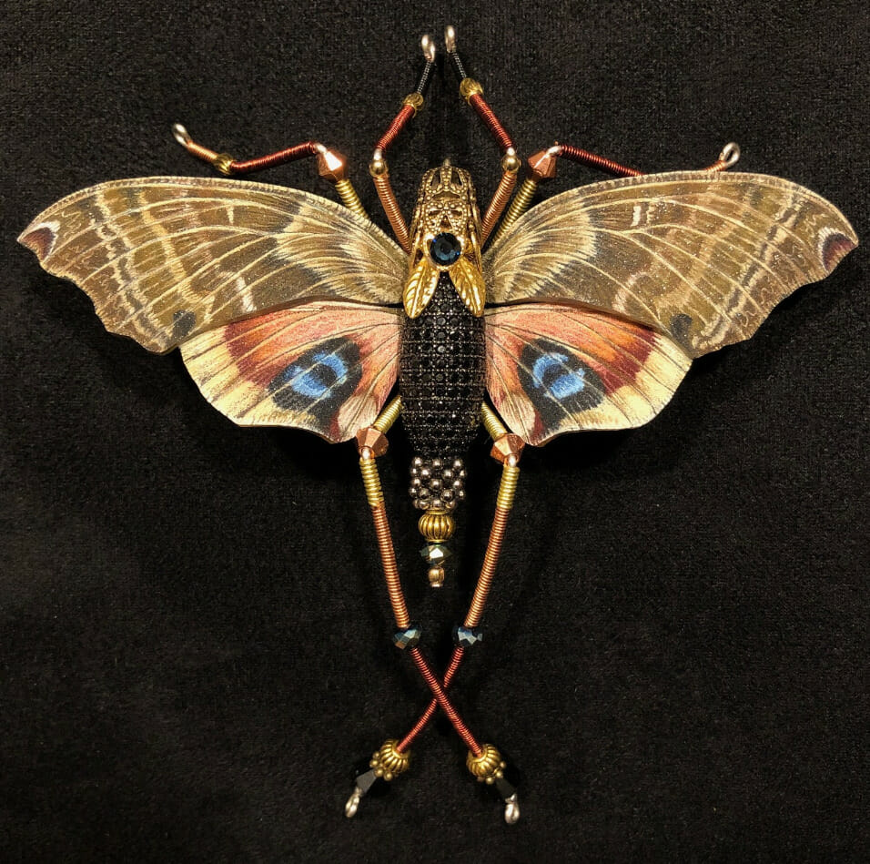 Brooch resembling a moth.