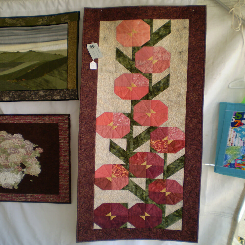 Guilt depicting flowers in a geometric style.