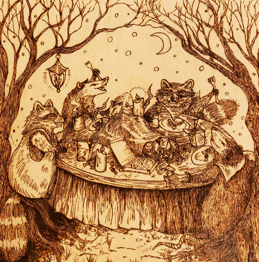 Hand wood-burned birch panel illustrating raccoons and rodents at a dinner table outdoors at night.