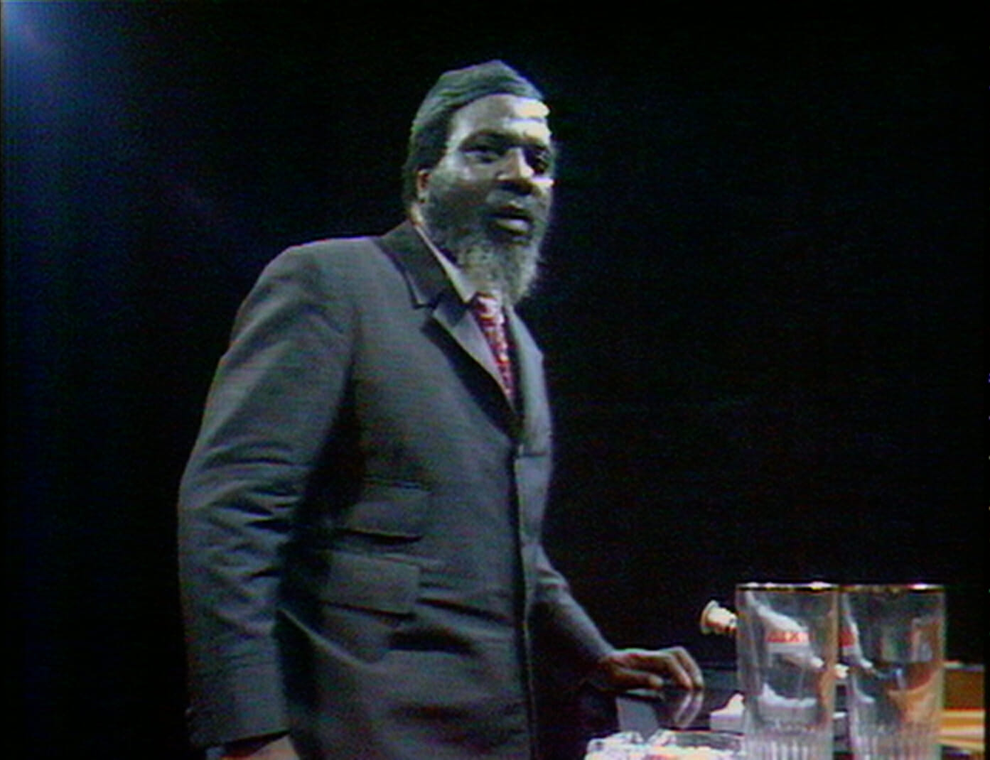 Film still from Rewind and Play showing Thelonious Monk standing.
