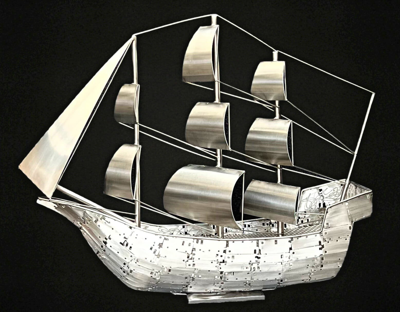 Metal sculpture of a sail boat.