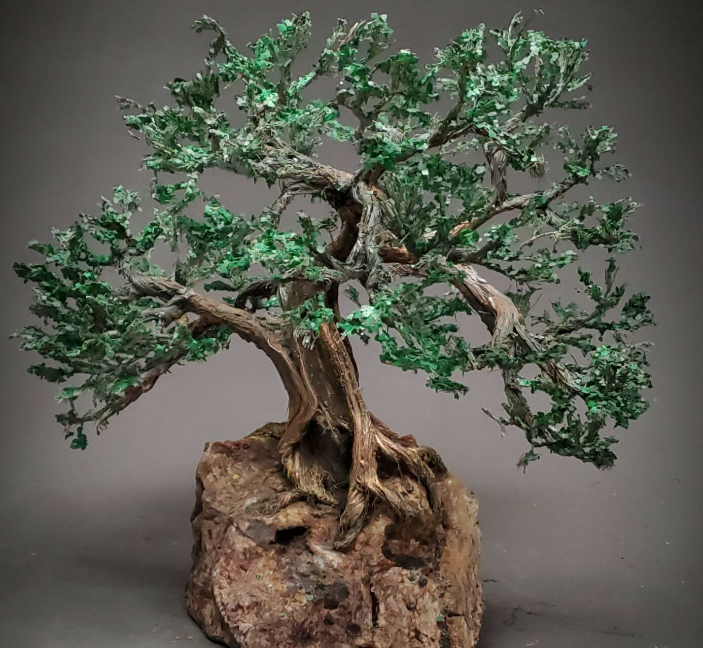 Sculpture made of copper wire which has been formed into a tree and mounted into a rock.