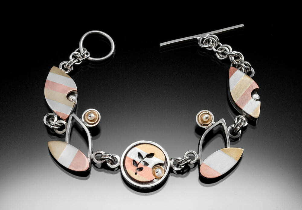 Metal bracelet with leaf shapes.