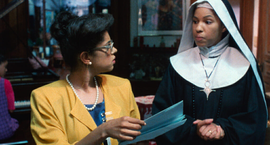 Film still showing a person wearing facing a nun.