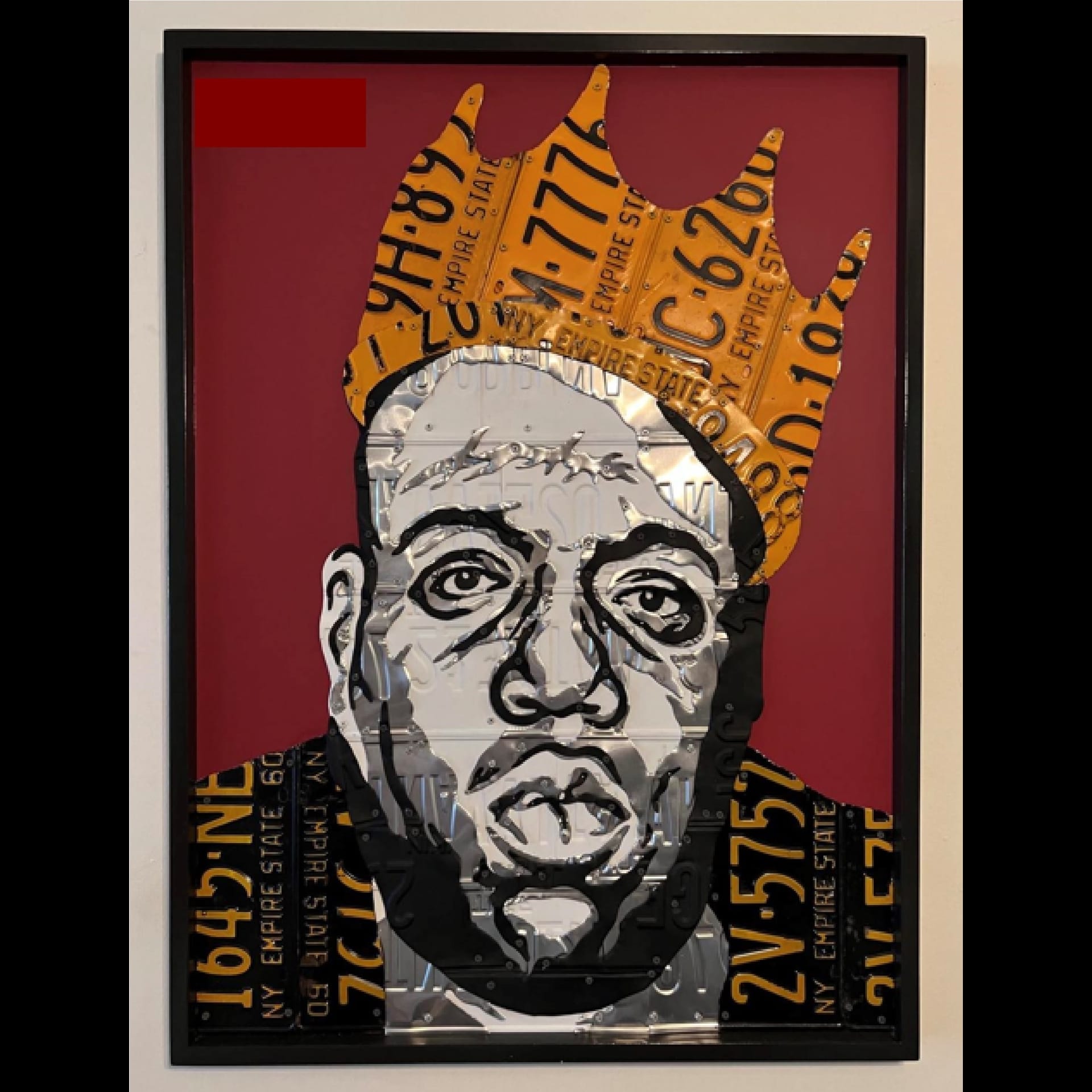A picture of a man with a crown made of collage.