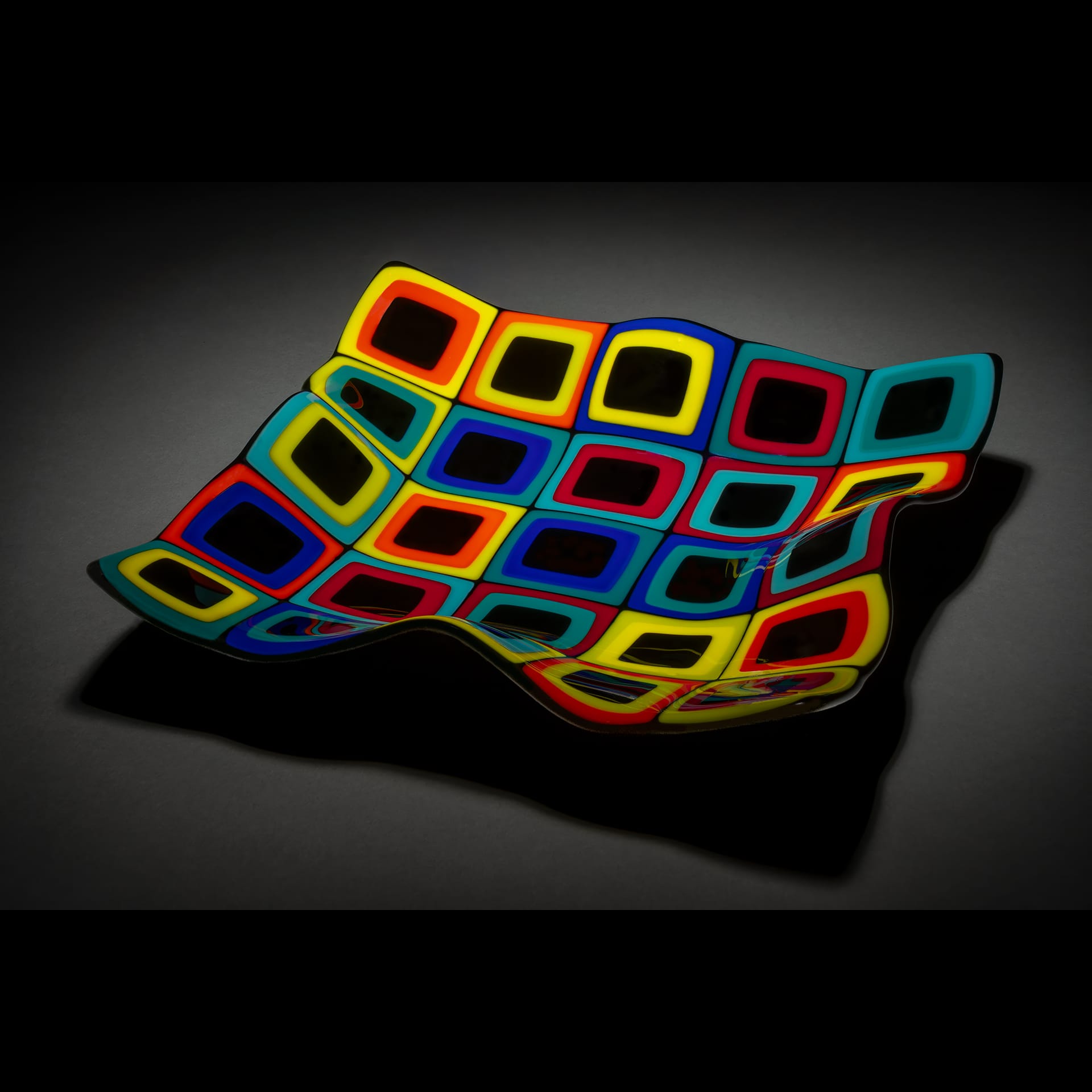 A tray made up of rainbow glass squares.