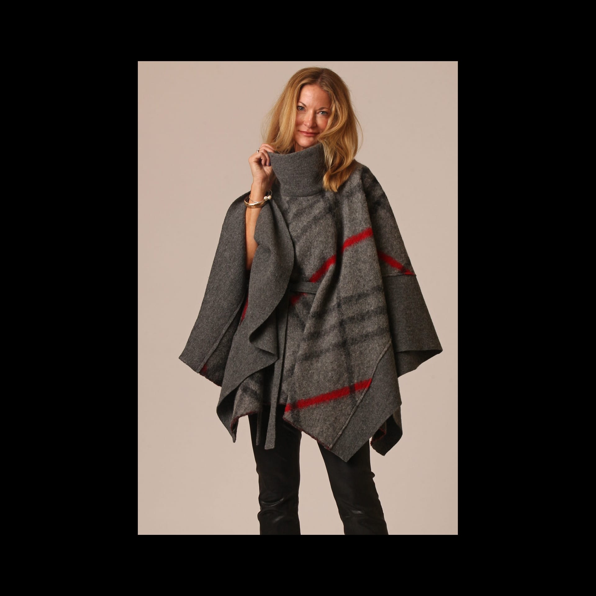 A woman in a grey shawl with red stripes.