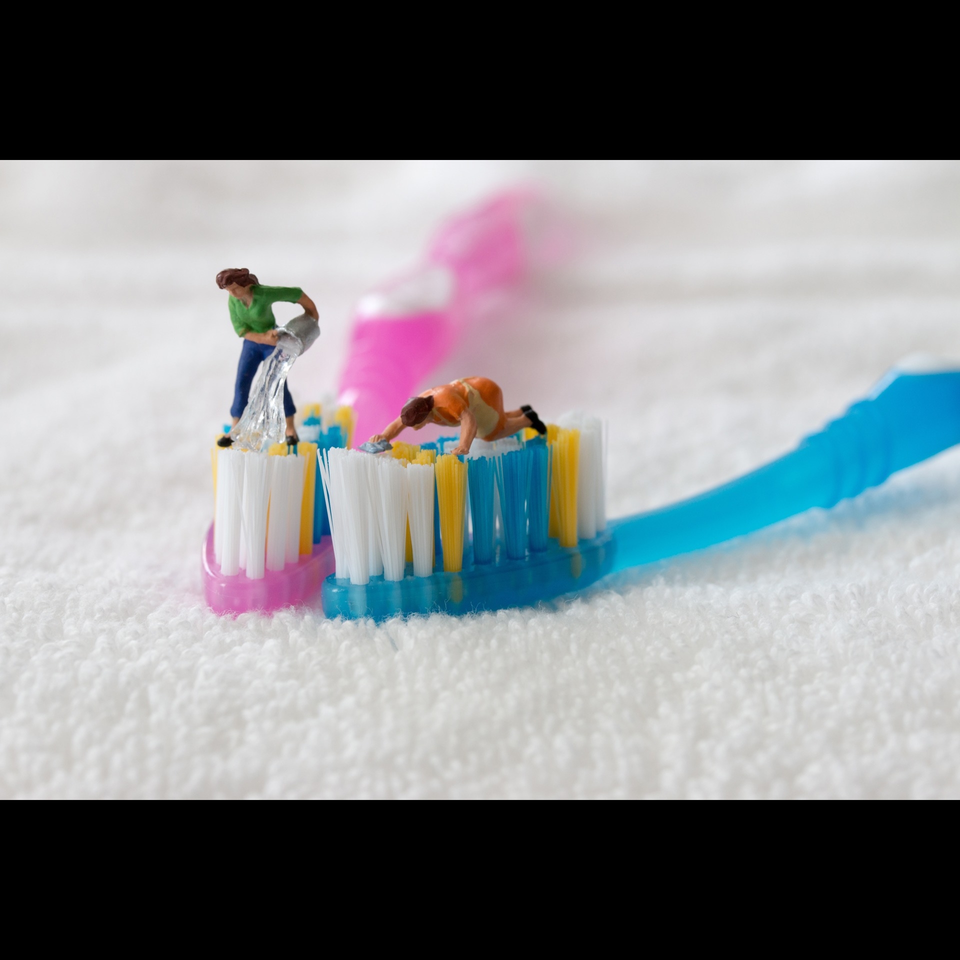 Small figurines of people on toothbrushes.
