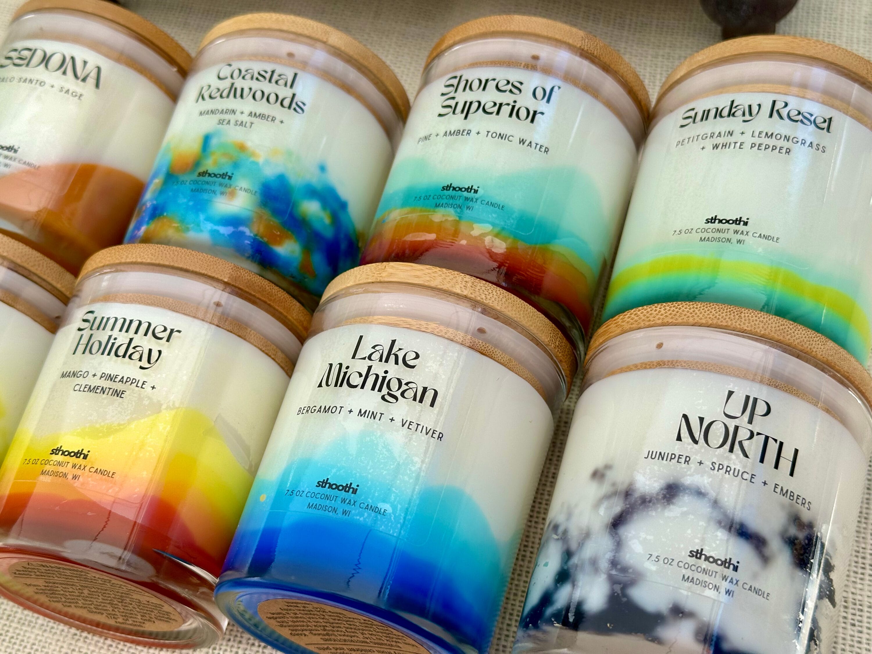 Many layered and colorful candles stacked in a box.