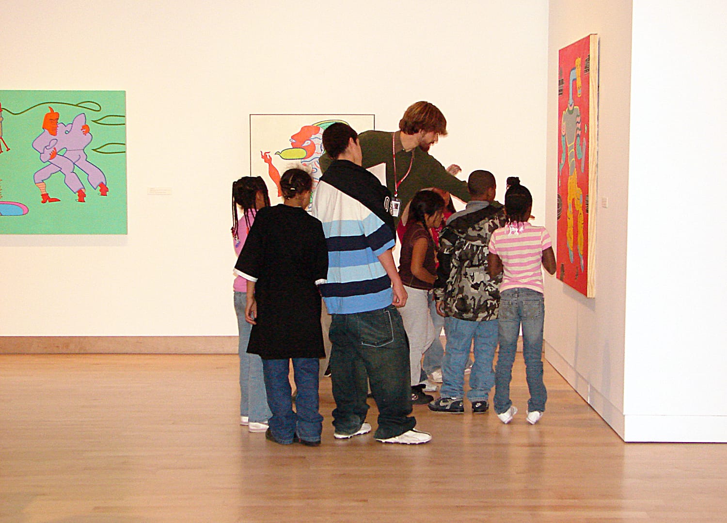 A group looking at art work.