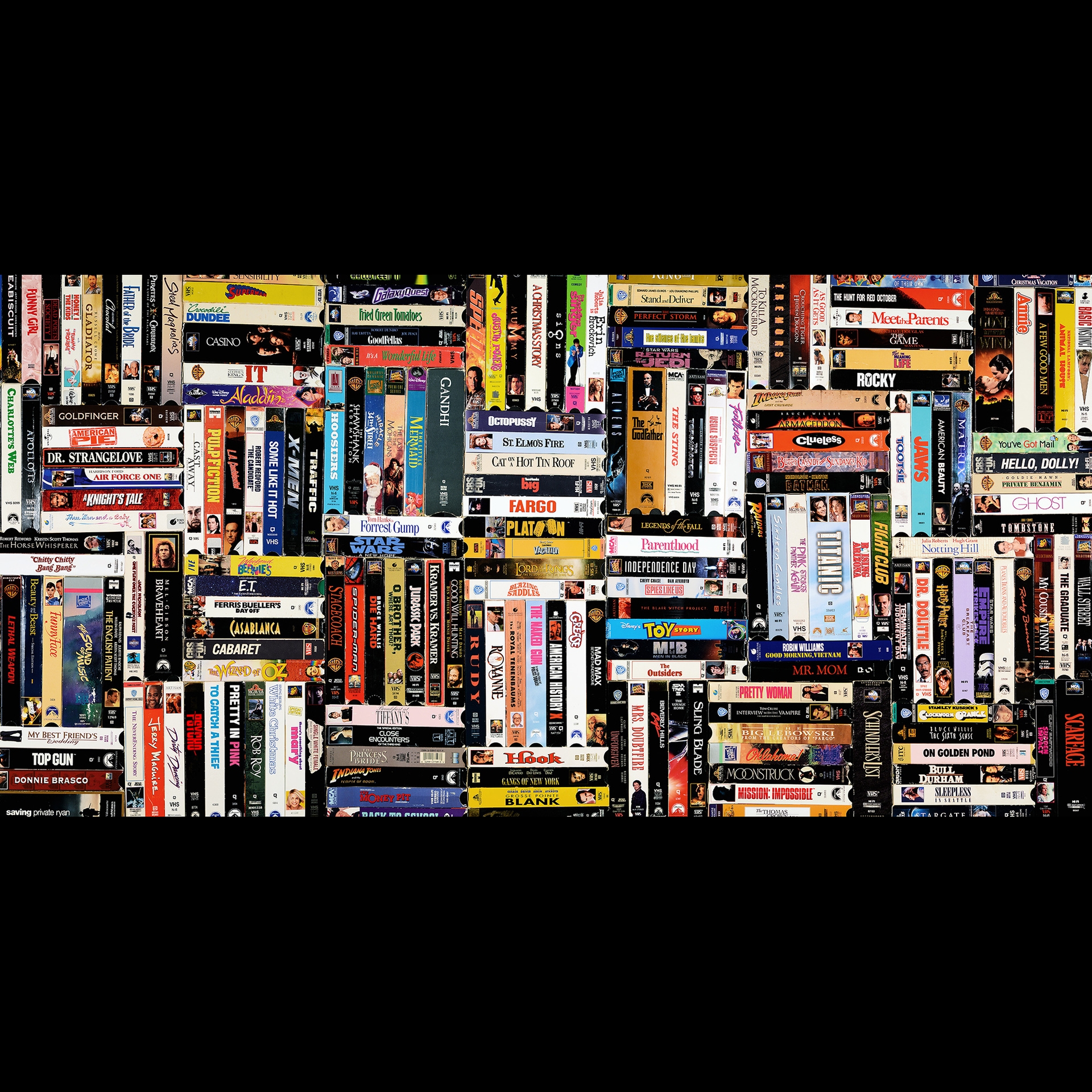 Many books in a patter on a shelf.