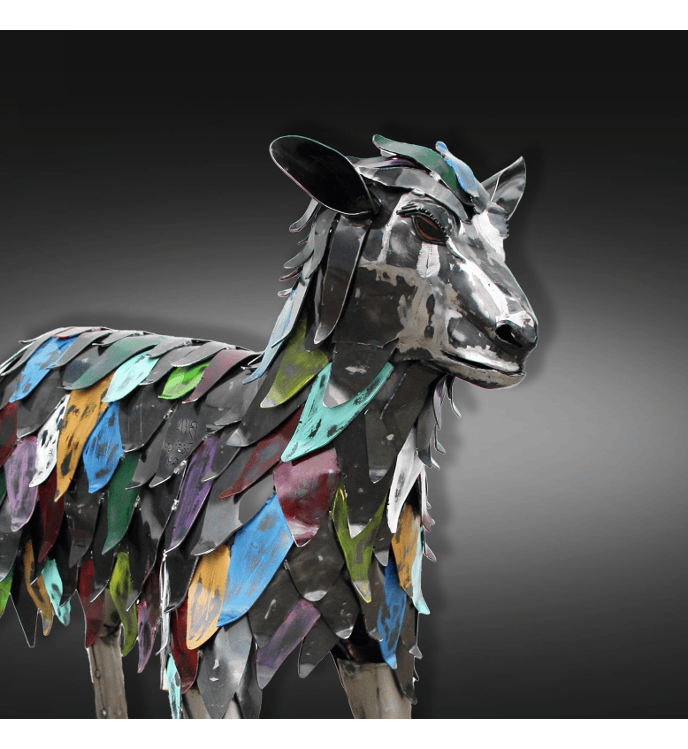 A metal sculpture of a goat.