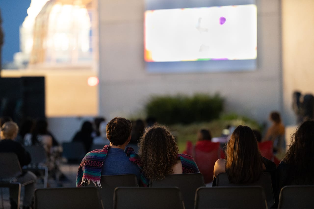 A crowd of people watching a film