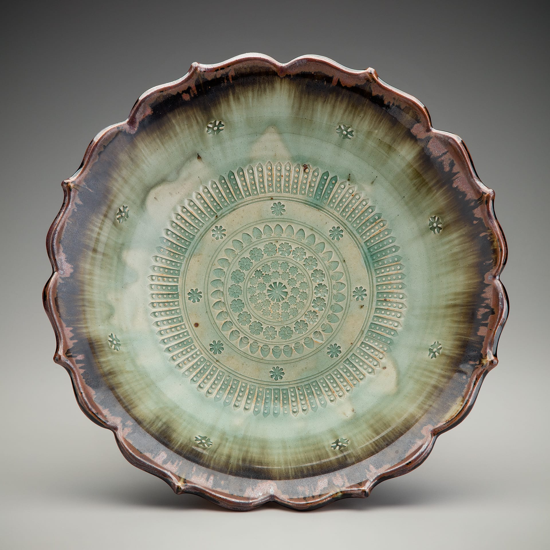 A plate with green and brown gradient glaze.