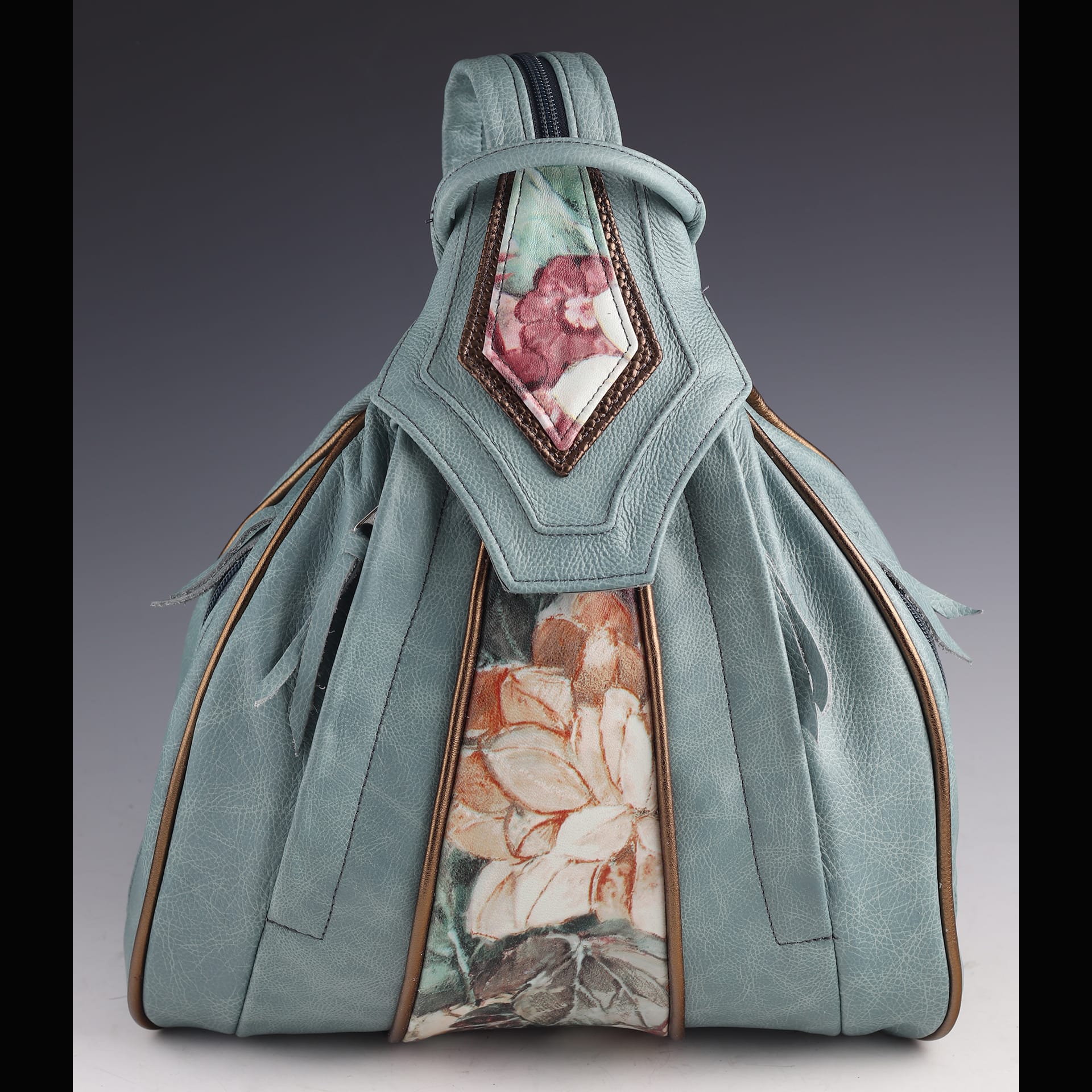 A blue bag with flower detailing.