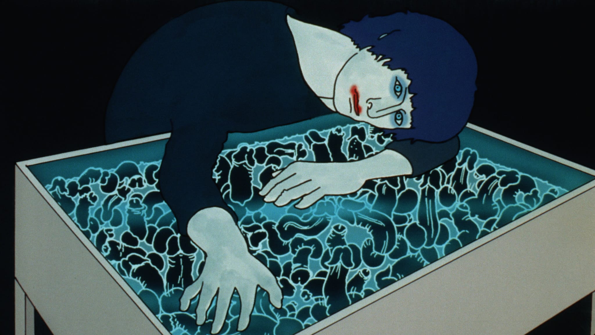 A person laying their head on a blue box.
