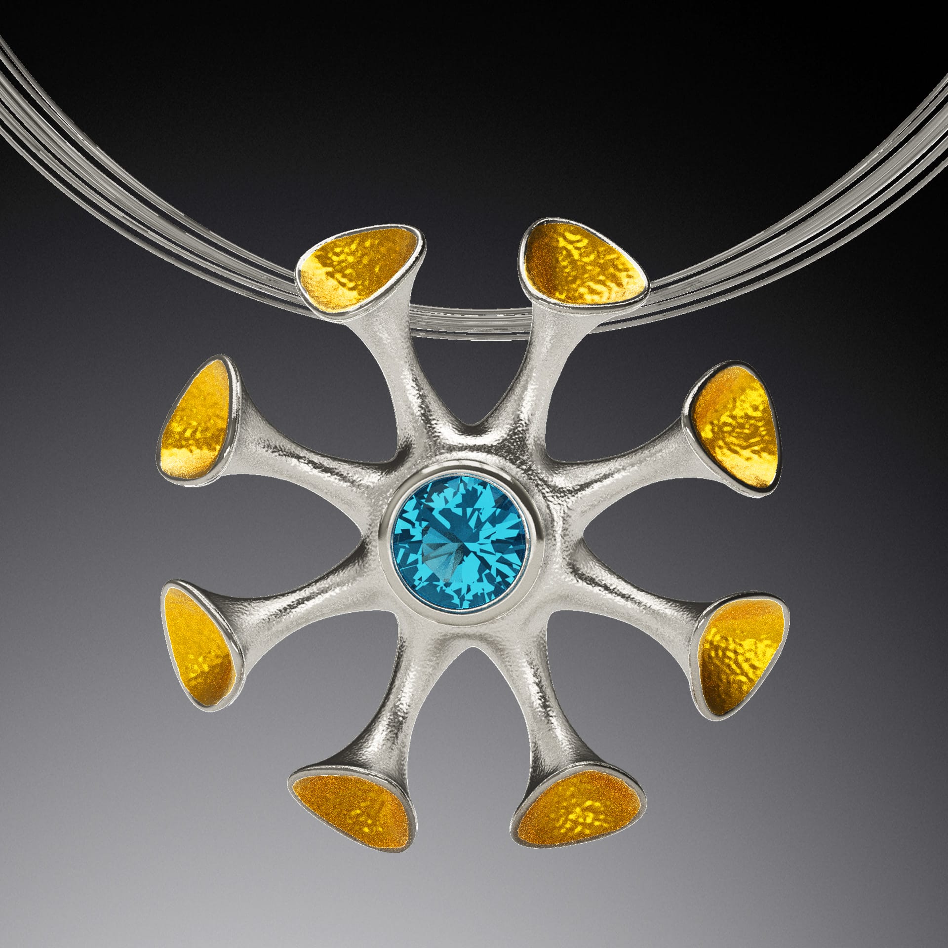 A pendant with a blue gem at the center of many gold stalks.