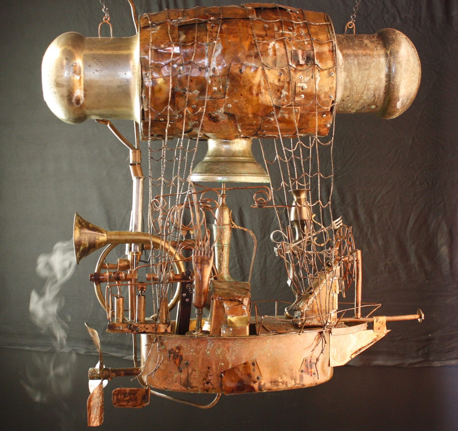 A brass version of a blimp like ship.